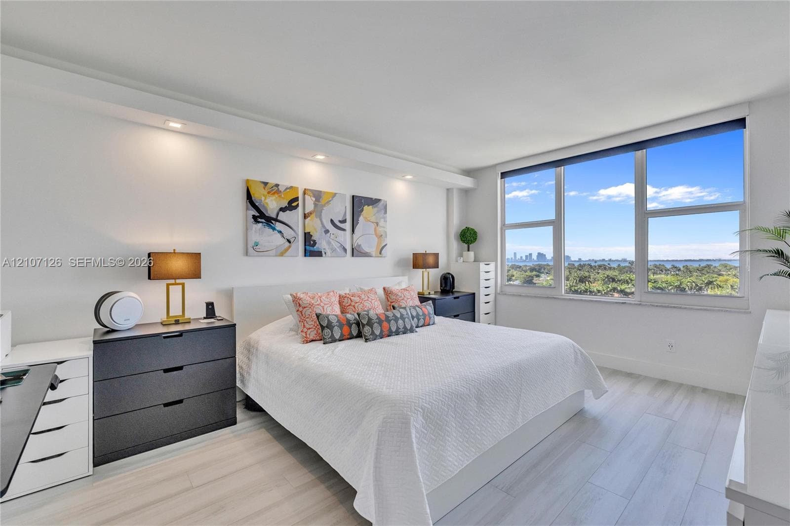 Floor-to-ceiling windows, wood-finish flooring, and recessed ceiling lighting