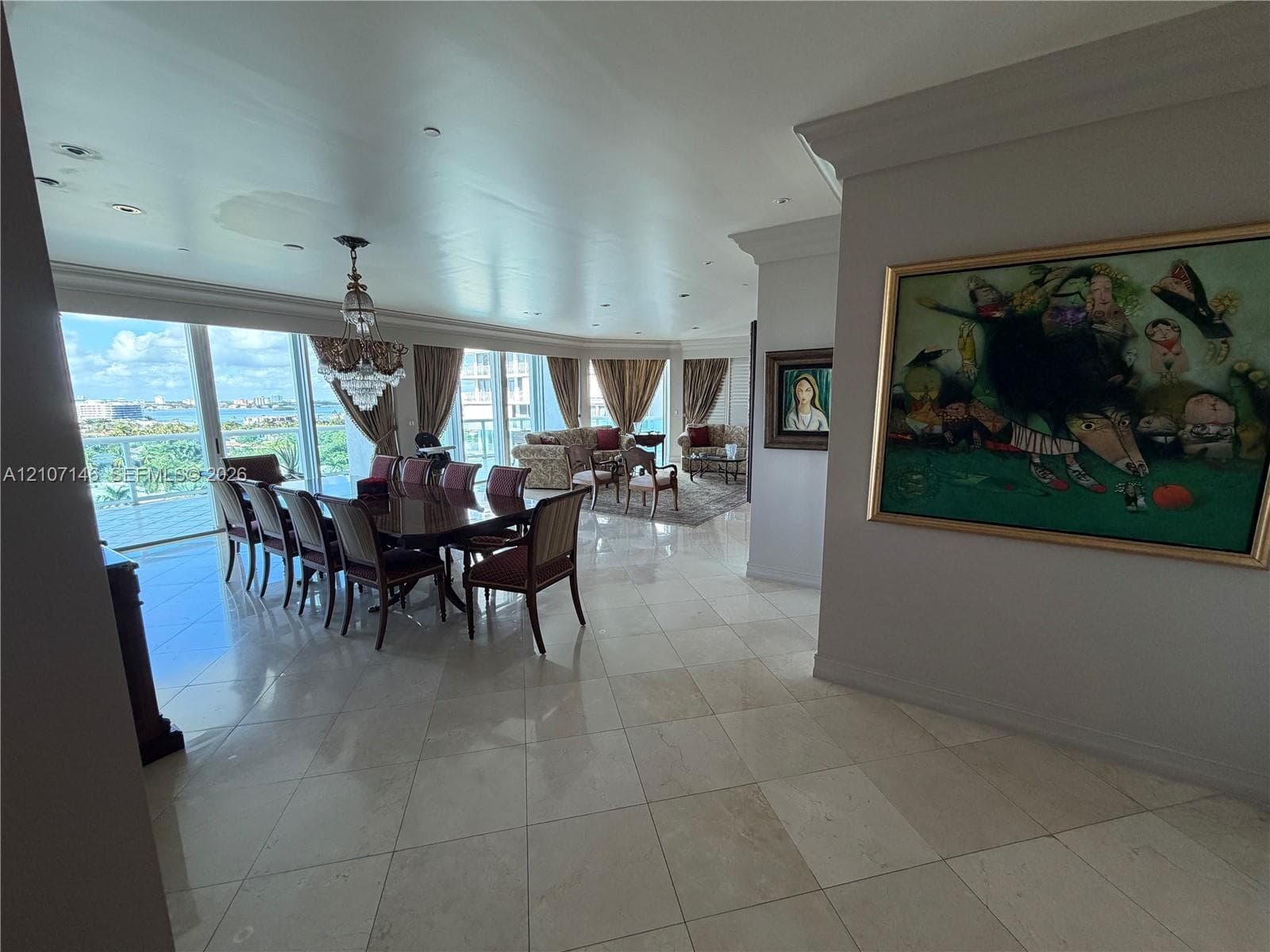 Large floor-to-ceiling windows featuring expansive natural lighting and wood-finish flooring