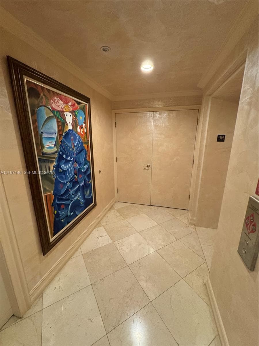 Hardwood flooring and a doorway featuring neutral-toned paint
