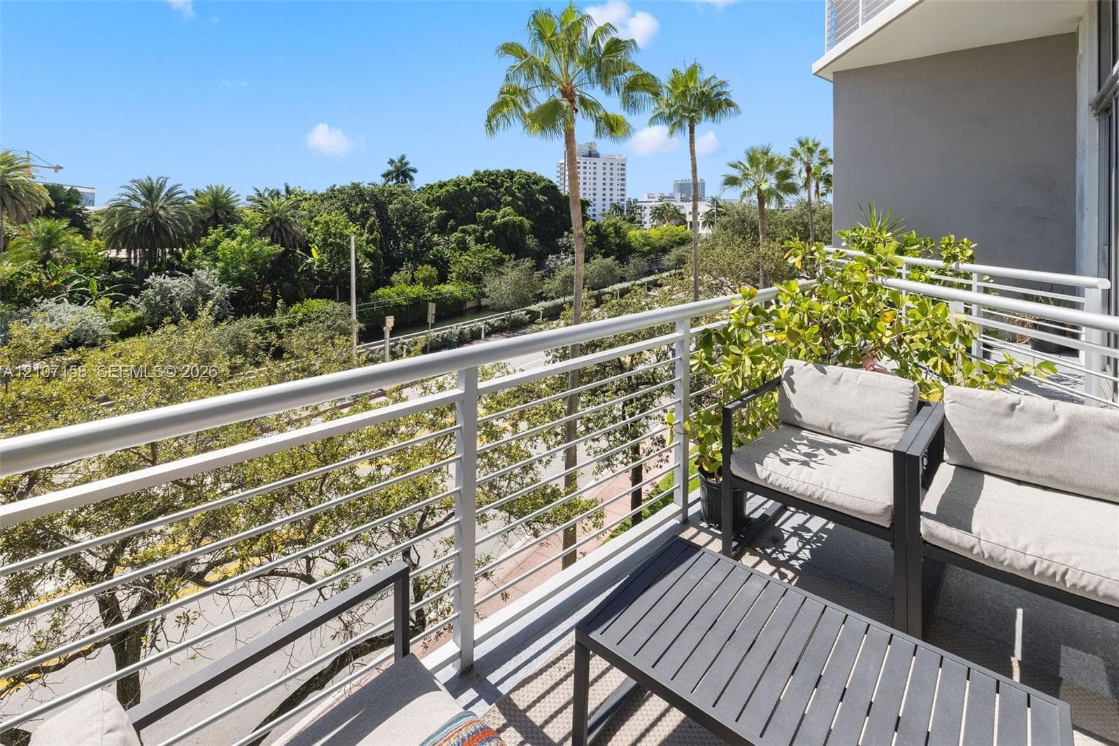 Private balcony featuring a metal railing system with horizontal cables and a concrete floor surface