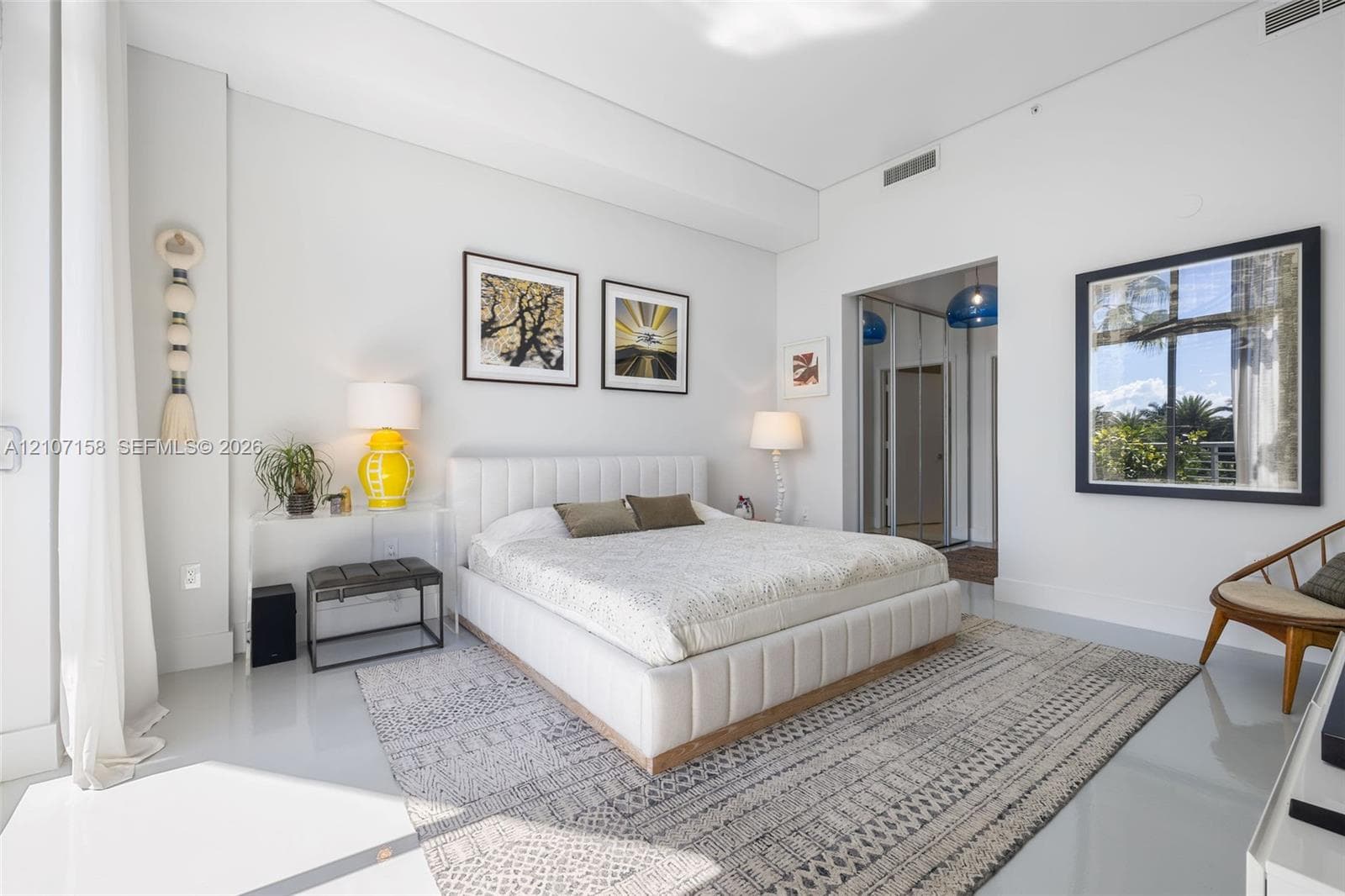 Expansive room featuring high ceilings, smooth flooring, and a large window