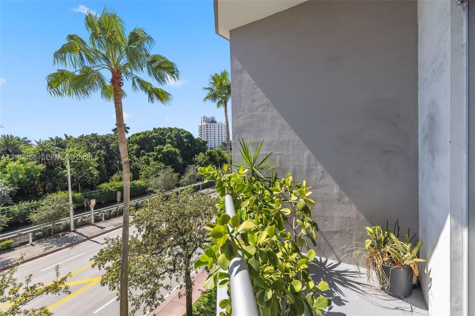 Private balcony featuring a grey concrete floor and a metal railing