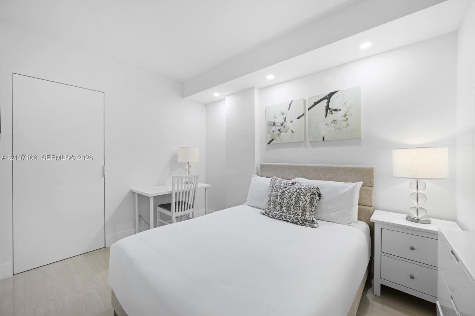 Room featuring recessed lighting, a smooth-finish door, and neutral-tone flooring
