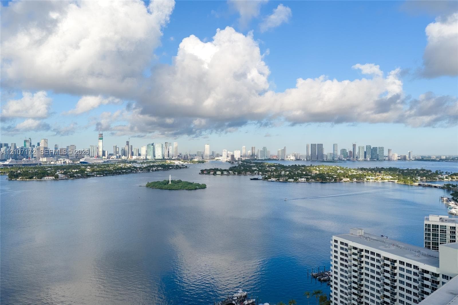 Panoramic water expanse featuring a skyline backdrop and coastal island silhouettes