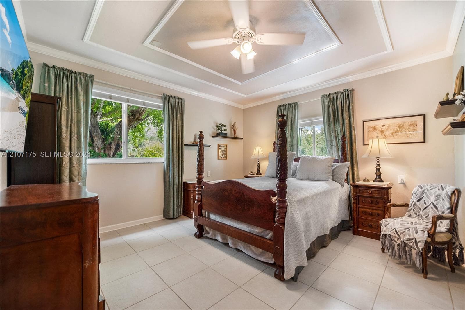 4th Bedroom en-suite could be used as 2nd primary, guest, inlaw or home office. Tray ceiling featuring decorative crown molding, large-format tile flooring, and dual closets.