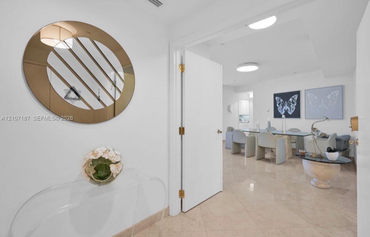 Polished stone tile flooring, neutral wall finishes, and flush-mount ceiling lighting
