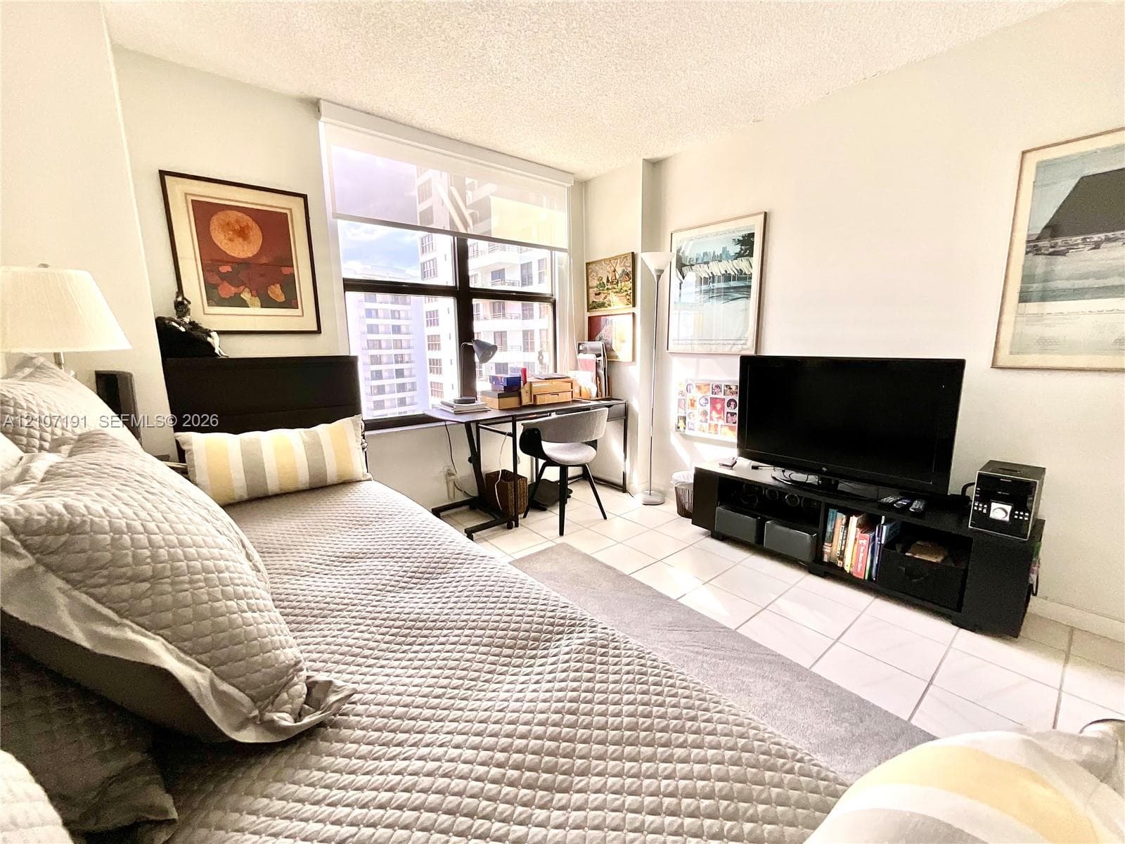 Large window with white roller shade and white ceramic tile flooring