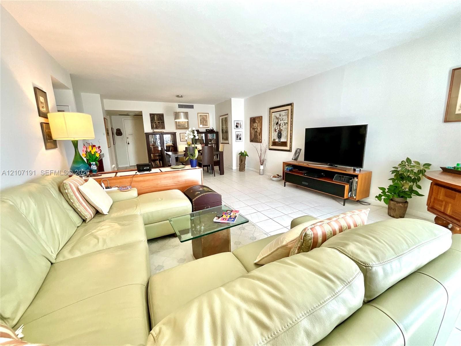 Open-concept interior featuring neutral wall tones and large-format tile flooring