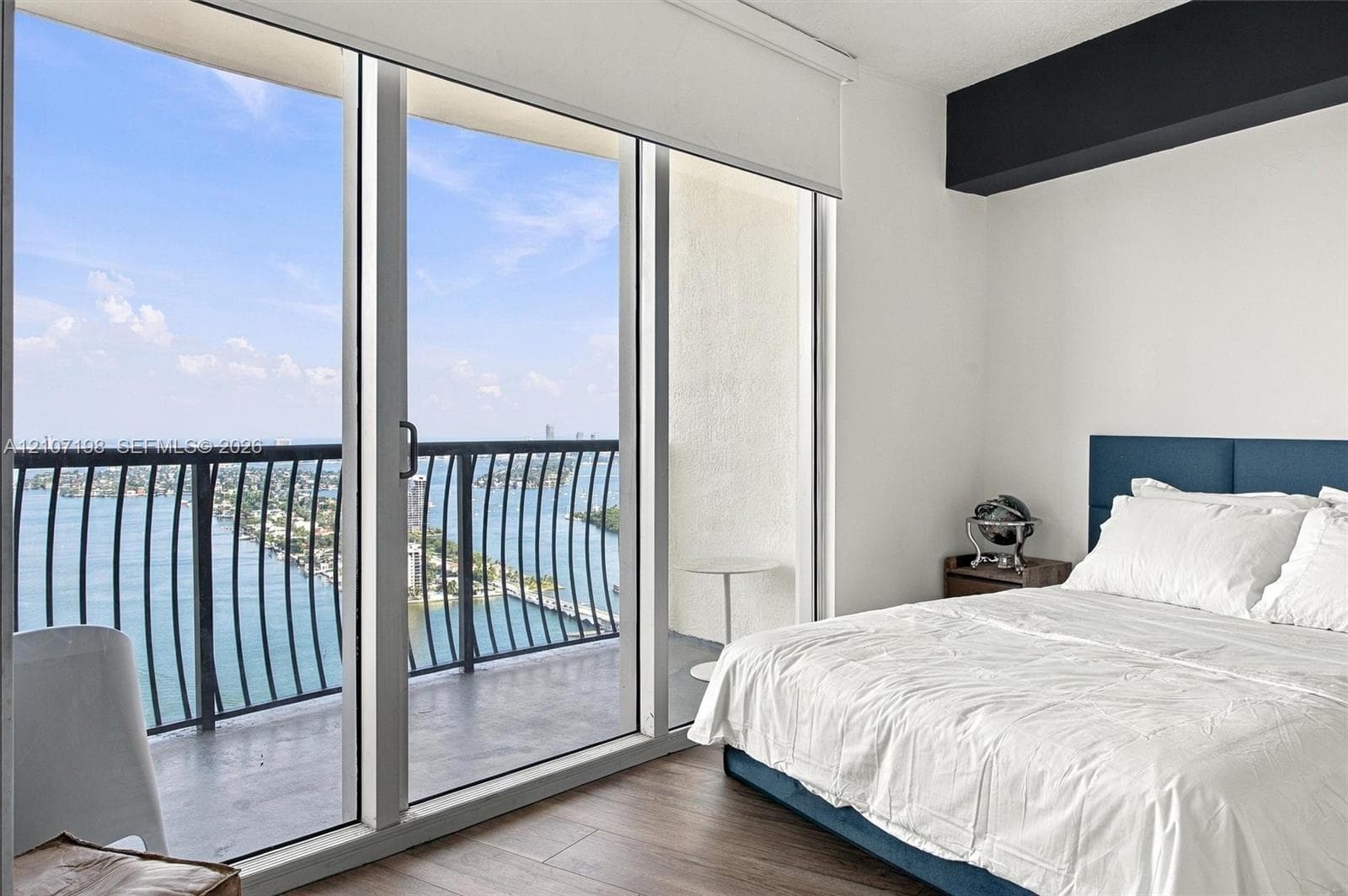 Interior space featuring wood-finish flooring, floor-to-ceiling sliding glass doors, and a vertical slat accent wall