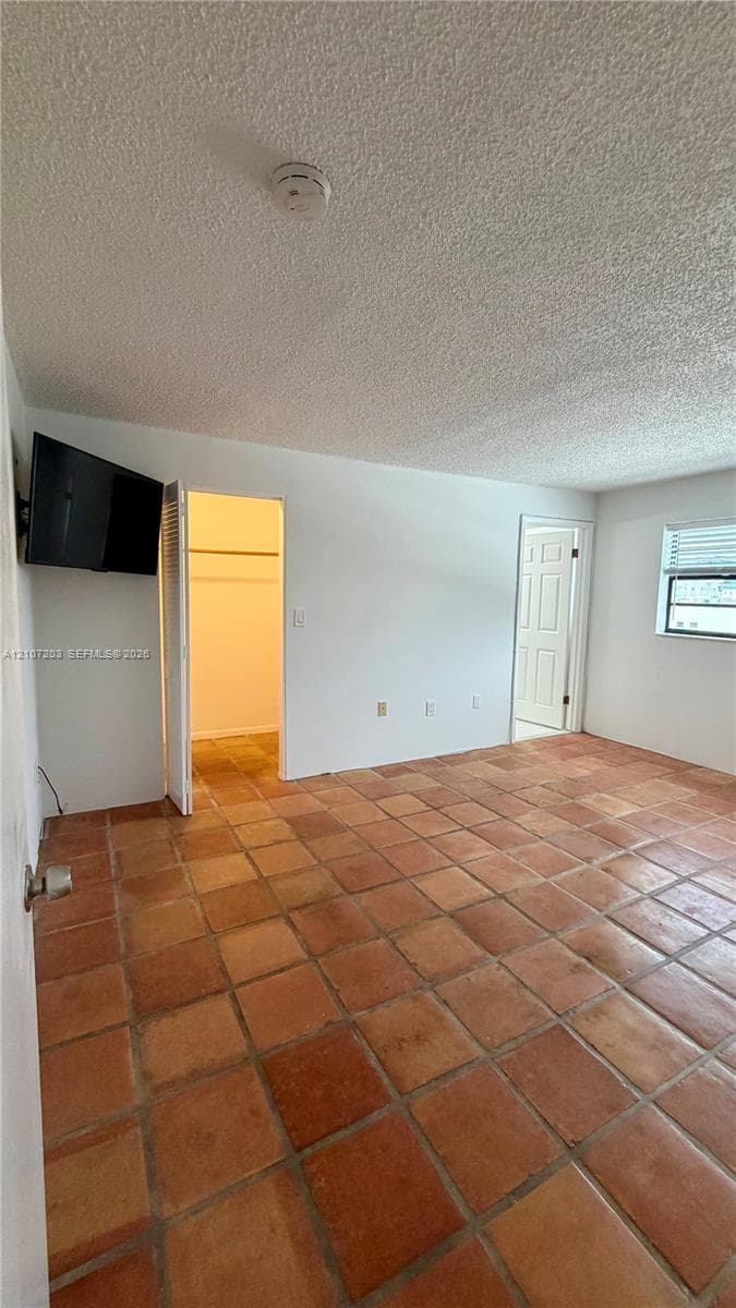Ceramic tile flooring, multi-panel interior door, and built-in closet shelving