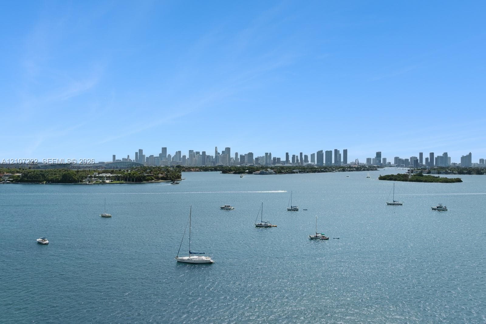 Expansive bayfront perspective featuring a panoramic skyline silhouette and open water with active marine traffic