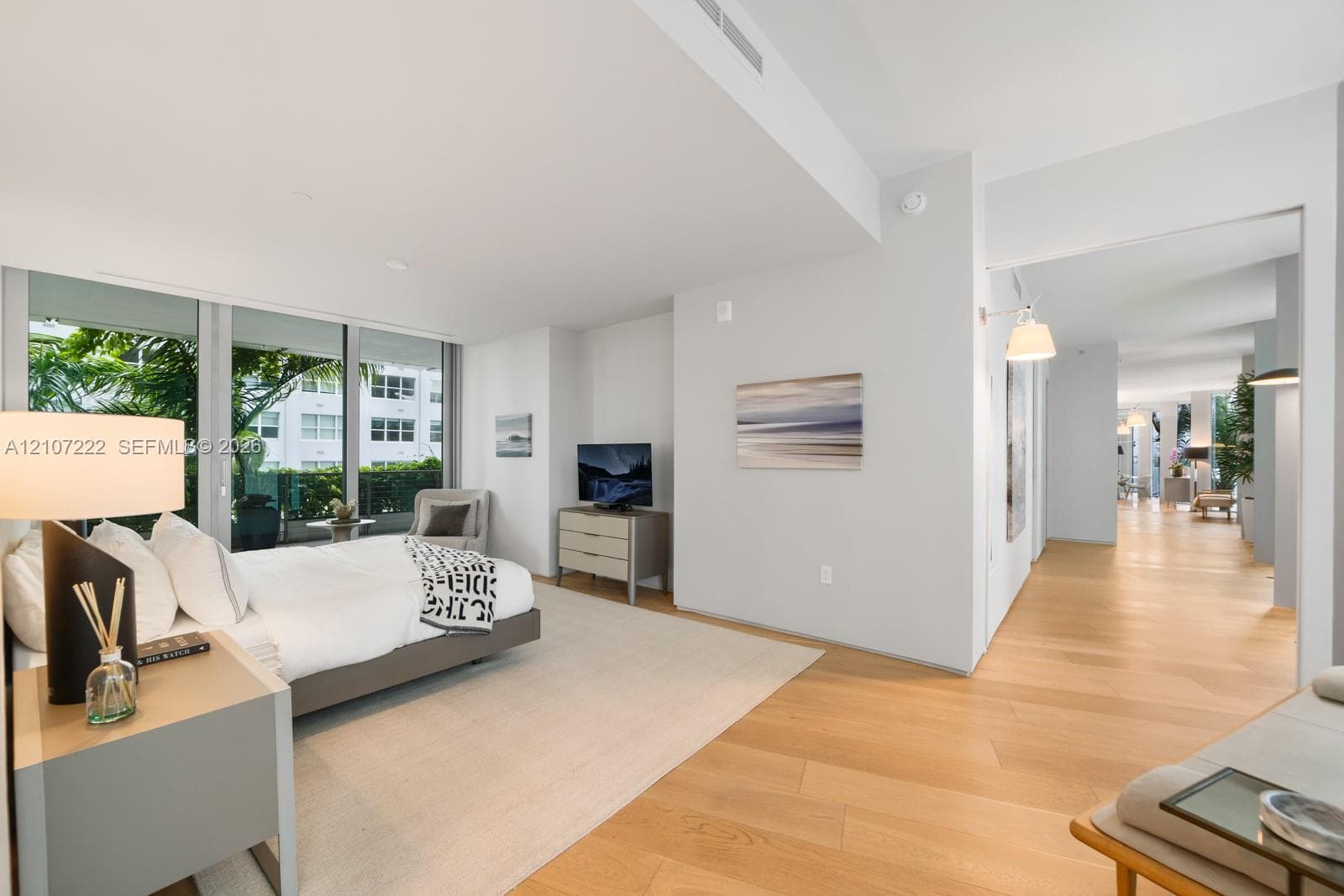 Floor-to-ceiling windows, wood-finish flooring, and recessed ceiling lighting