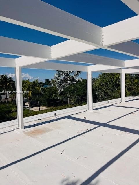 Rooftop terrace featuring a white pergola structure and smooth, leveled decking