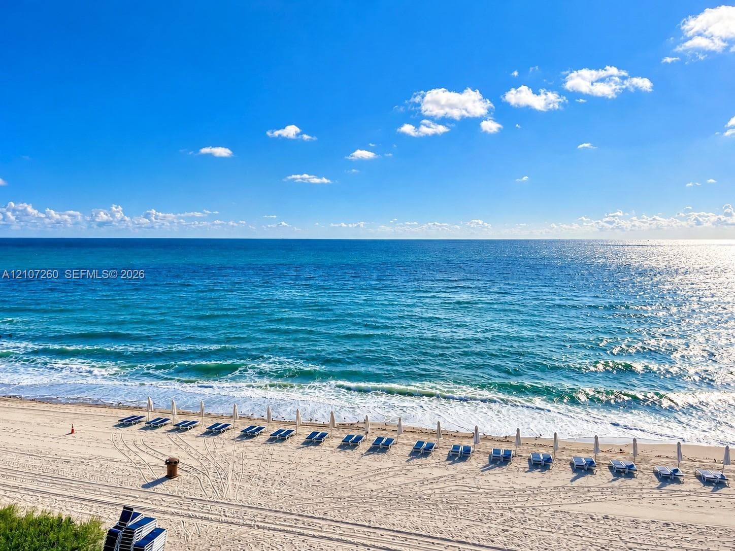 Direct oceanfront location featuring a wide sandy beach, shoreline access, and unobstructed maritime horizon
