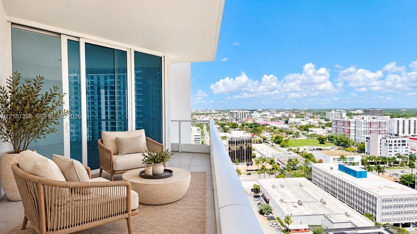 Private balcony featuring oversized tile flooring, glass panel railings, and floor-to-ceiling sliding glass doors ( AI used for interiors )
