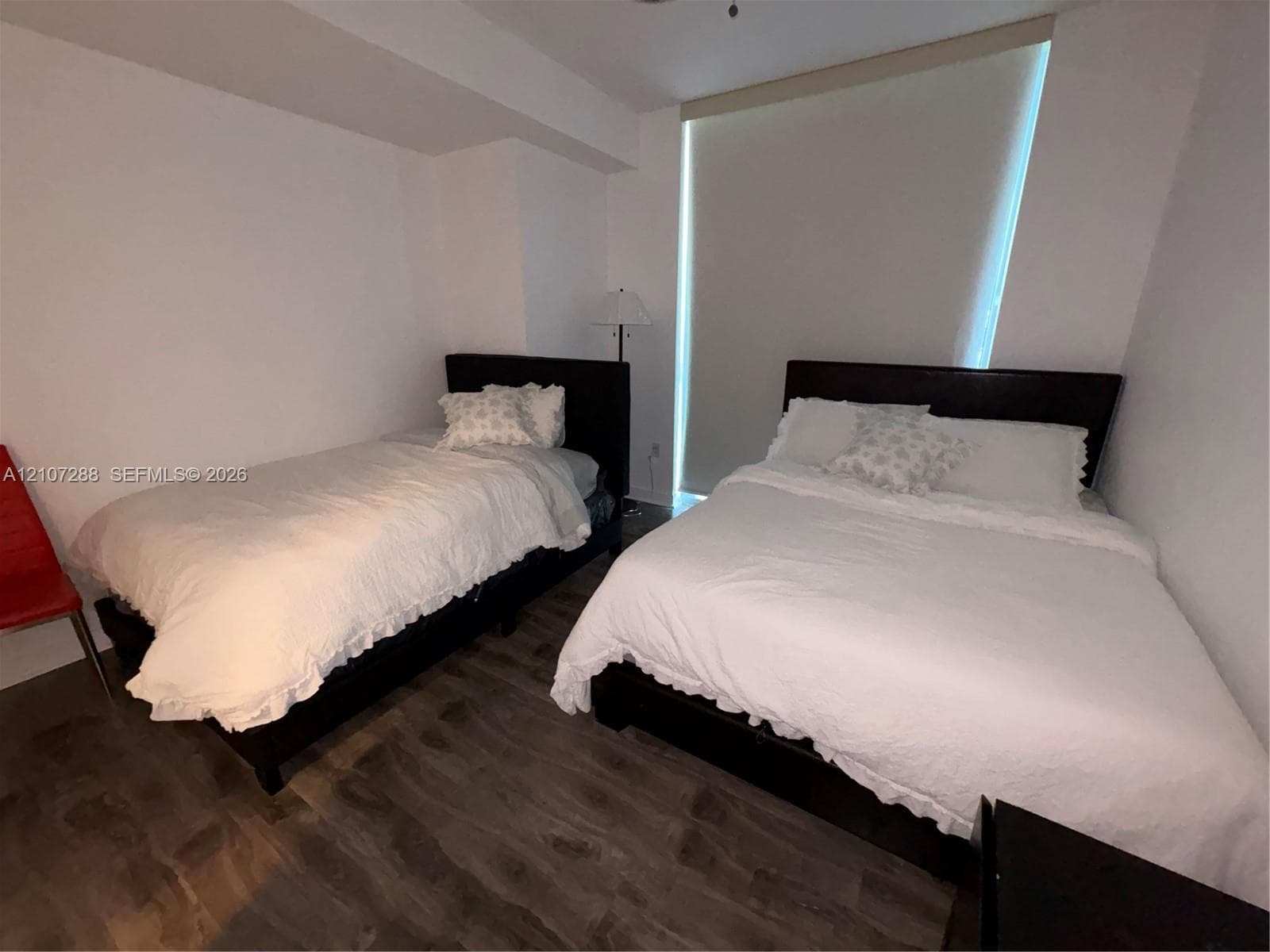 Wood-finish flooring and floor-to-ceiling window covering