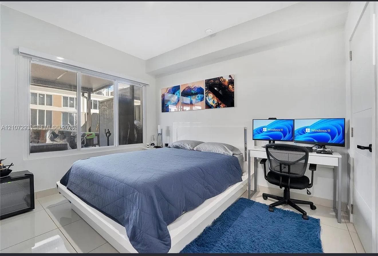 Large picture window featuring aluminum framing, neutral wall tones, and polished tile flooring