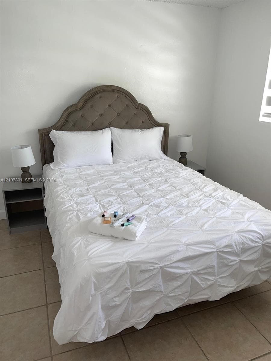Neutral wall finish with large-format tile flooring and natural light entry