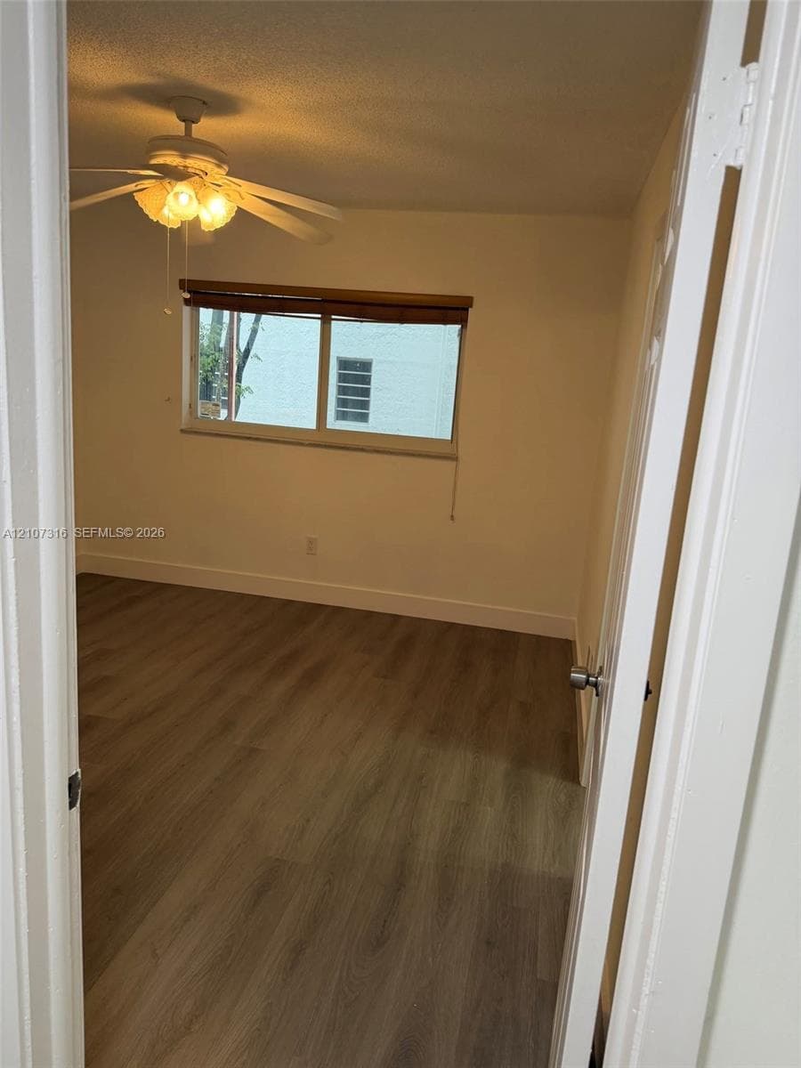 Wood-finish flooring, ceiling fan with integrated light fixture, and horizontal sliding window