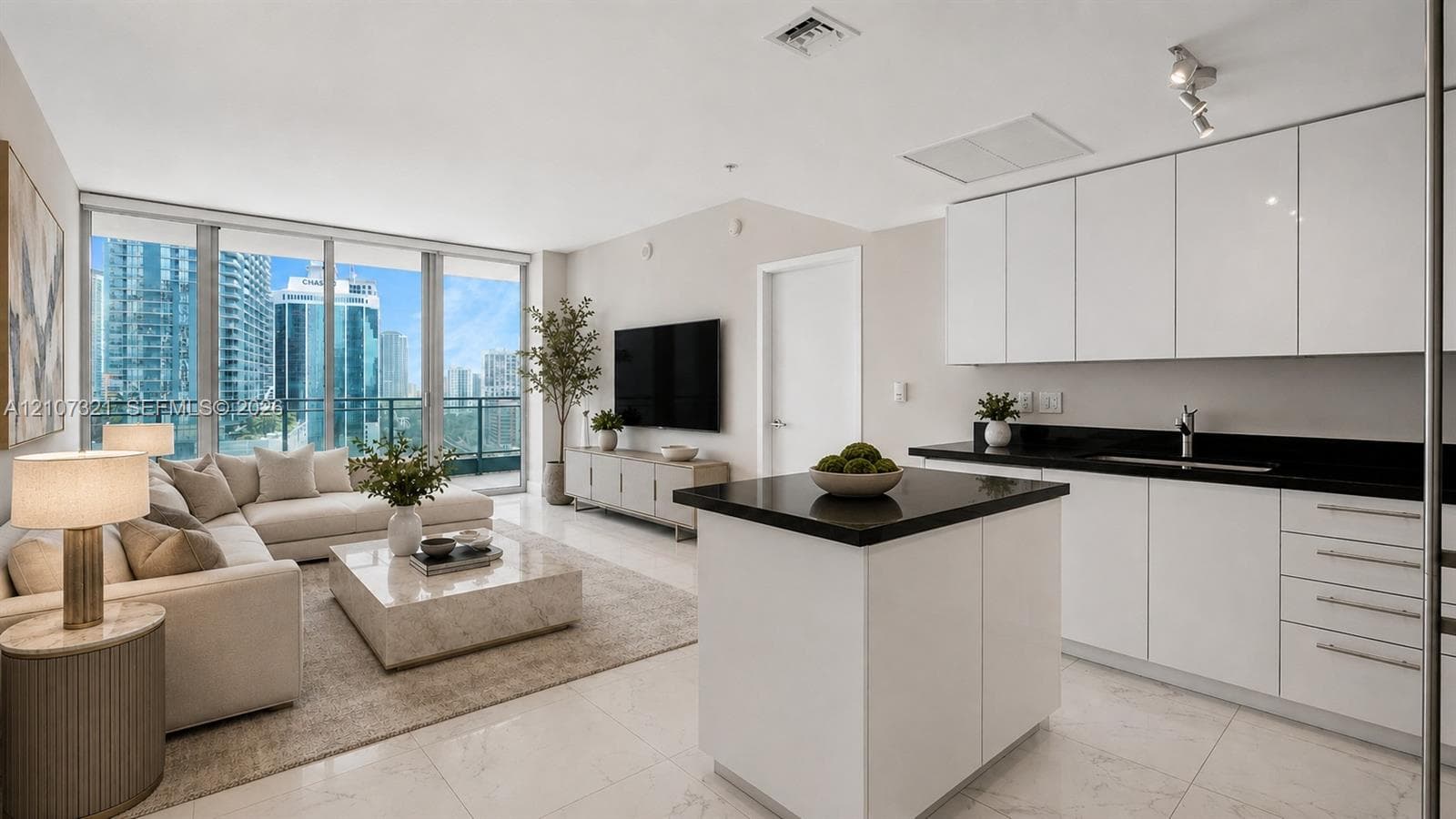 Open-concept interior featuring floor-to-ceiling windows, high-gloss white cabinetry, contrasting dark countertops, an island with built-in prep space, and polished stone-finish flooring