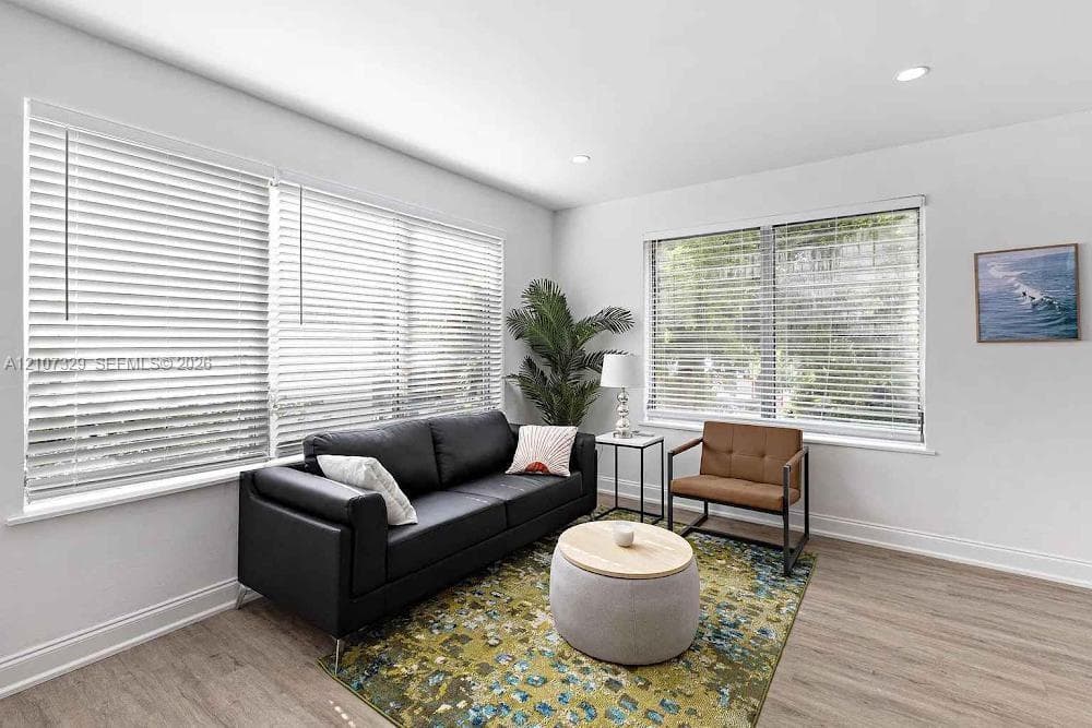 Spacious living room with large windows and modern decor.