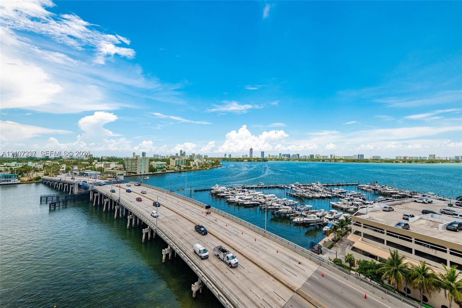Aerial perspective overlooking a multi-slip marina, expansive waterway, and coastal bridge infrastructure