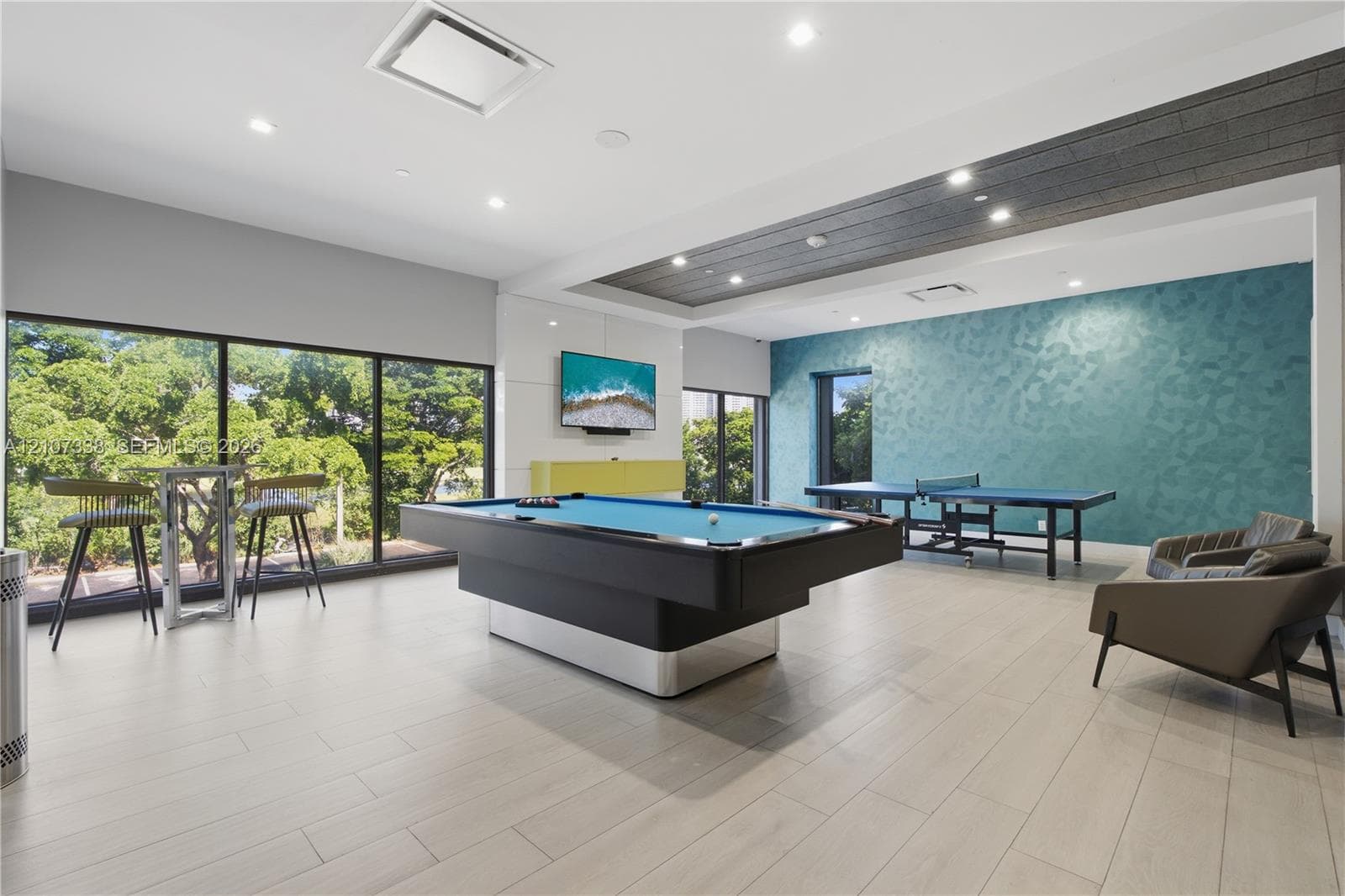 Recreation room featuring floor-to-ceiling windows, wood-finish flooring, recessed lighting, and a coffered ceiling with wood-plank detailing