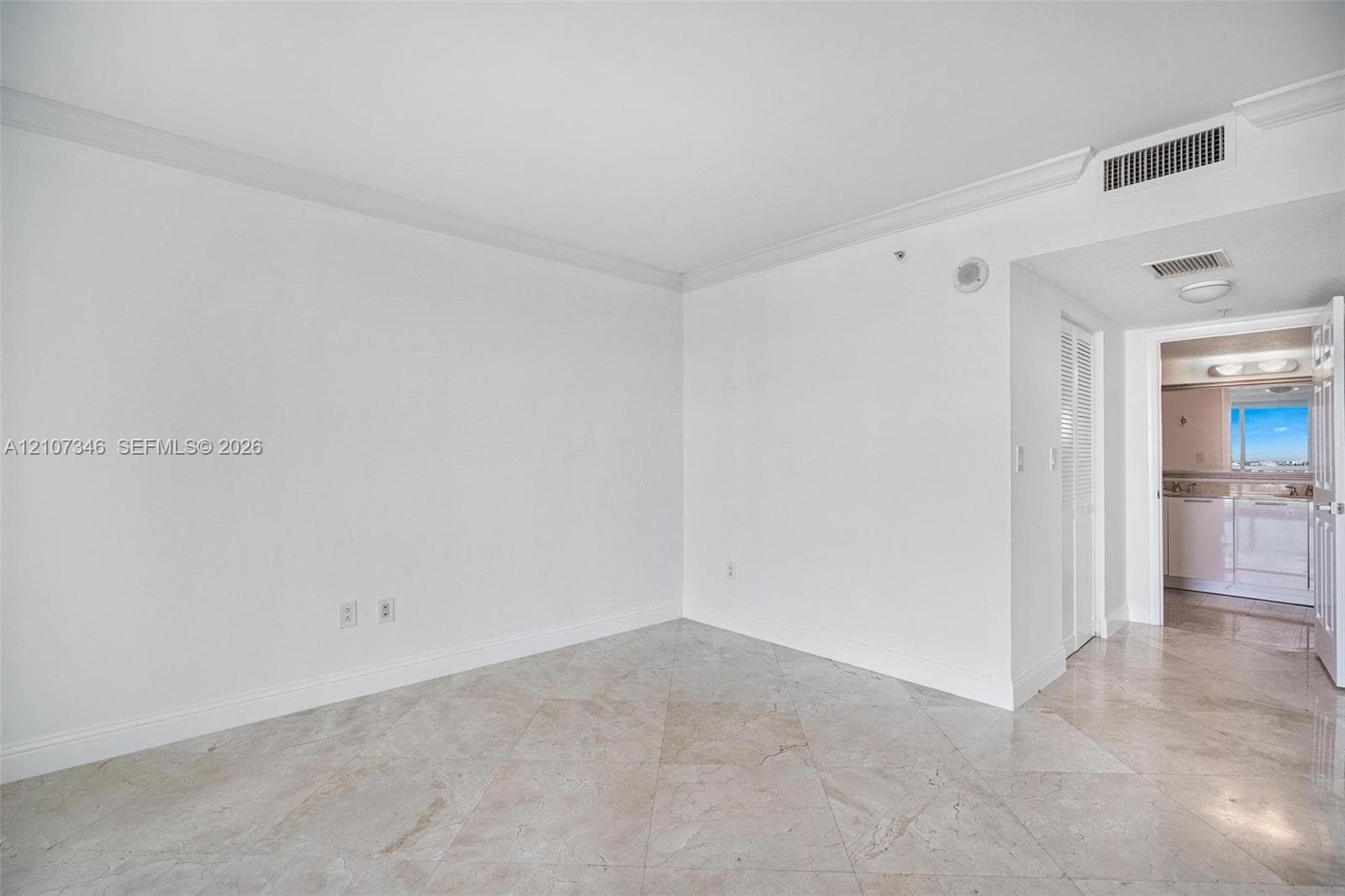 Neutral-toned flooring, crown molding, and high ceilings