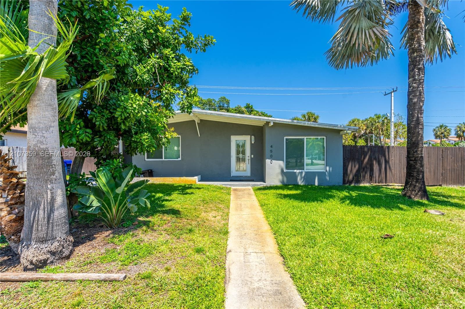 Additional exterior view highlighting the home and surrounding yard
