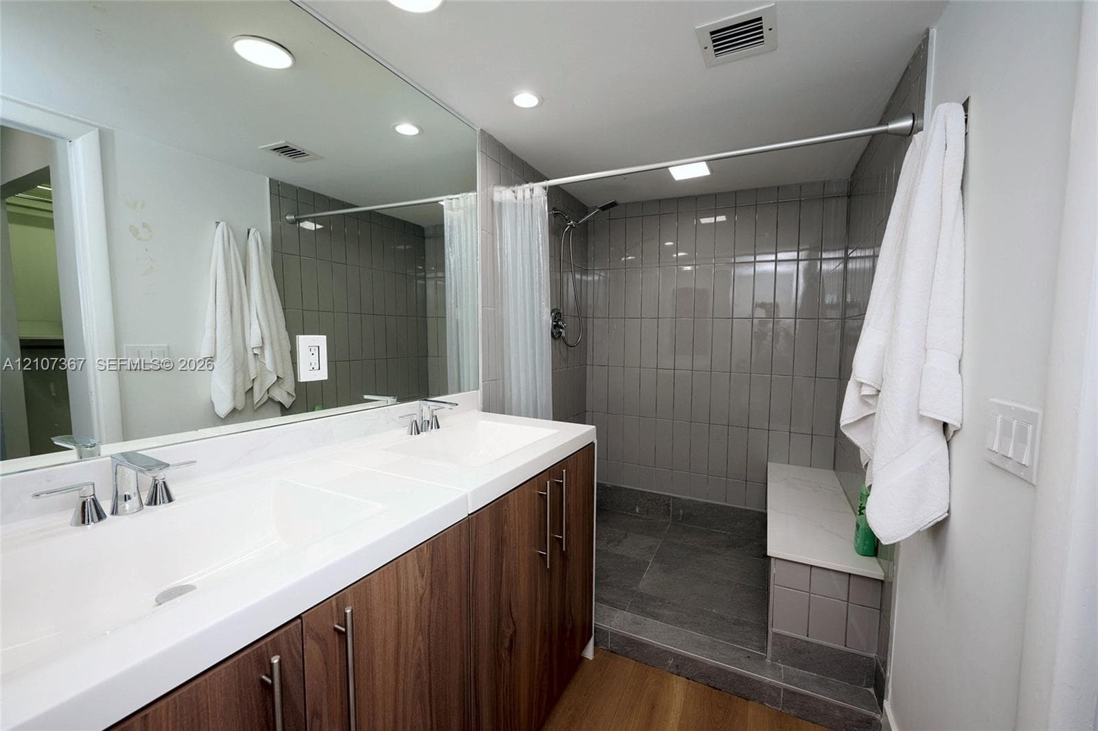 Room featuring wood-finish flooring and large multi-pane windows