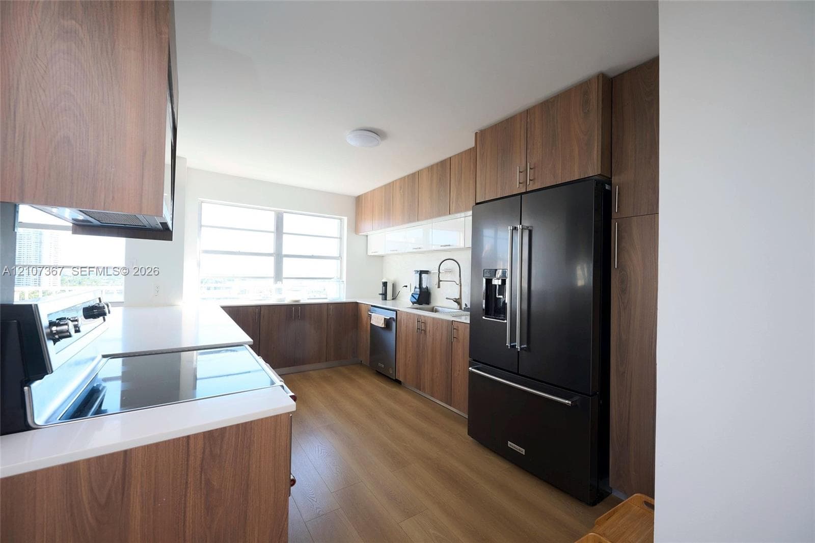 Interior space featuring wood-finish flooring, recessed ceiling lighting, and crisp white wall finishes
