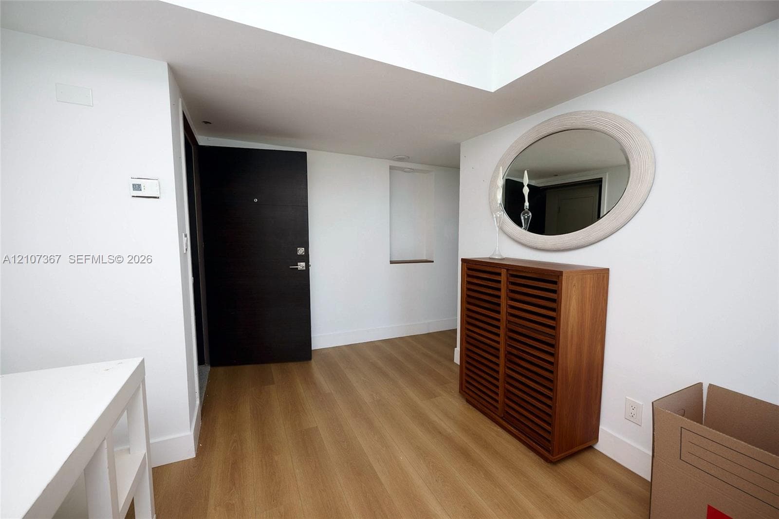 Interior space featuring wood-finish flooring and expansive windows with horizontal window panes