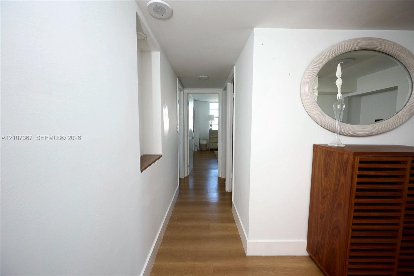 Bright room featuring large multi-pane windows and wood-finish flooring