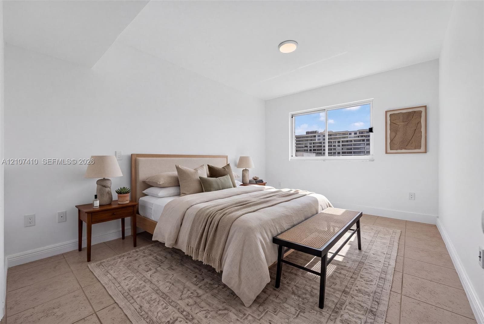 Room featuring light-toned tile flooring, neutral wall finishes, and a sliding horizontal window
