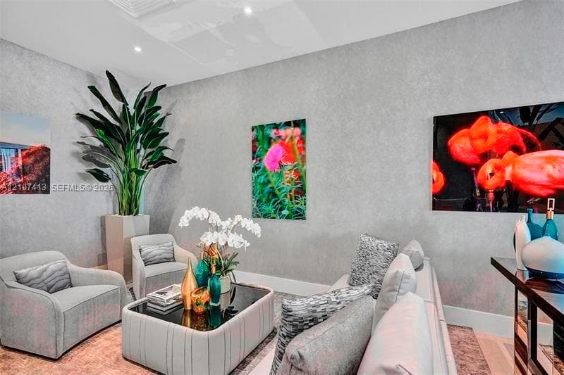 Textured grey wall finish, recessed ceiling lighting, and neutral-toned flooring