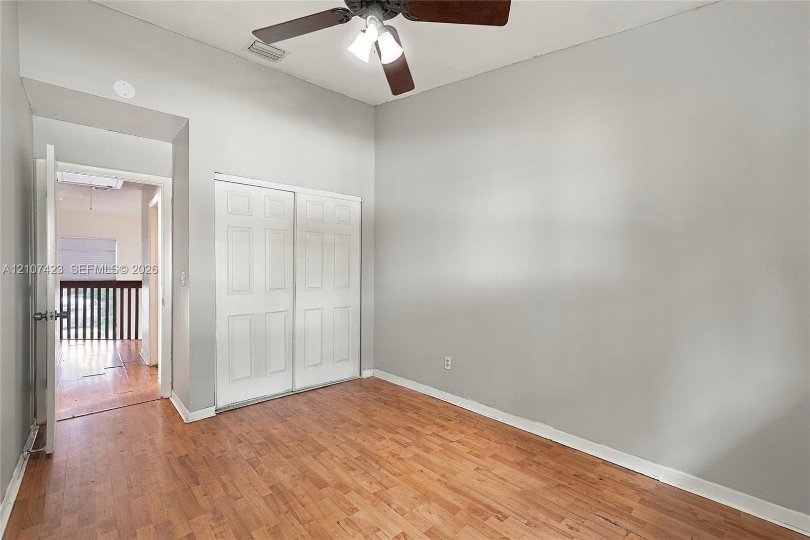 Vaulted ceilings, wood-finish flooring, and a ceiling fan with integrated lighting