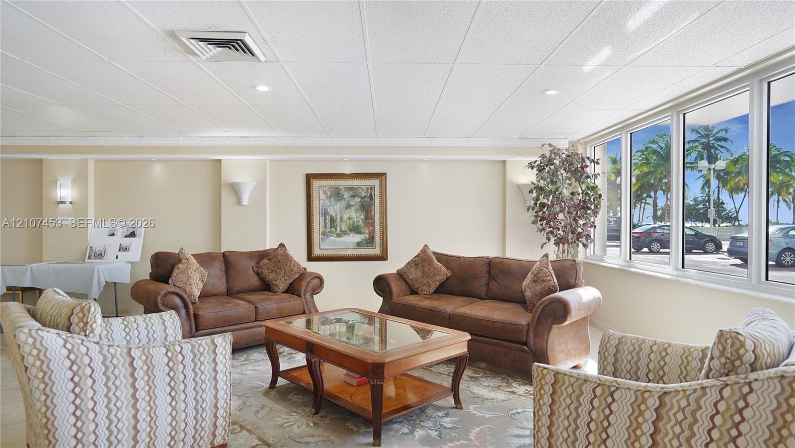 Expansive windows providing natural light, neutral wall finishes, recessed lighting, and wall-mounted sconces