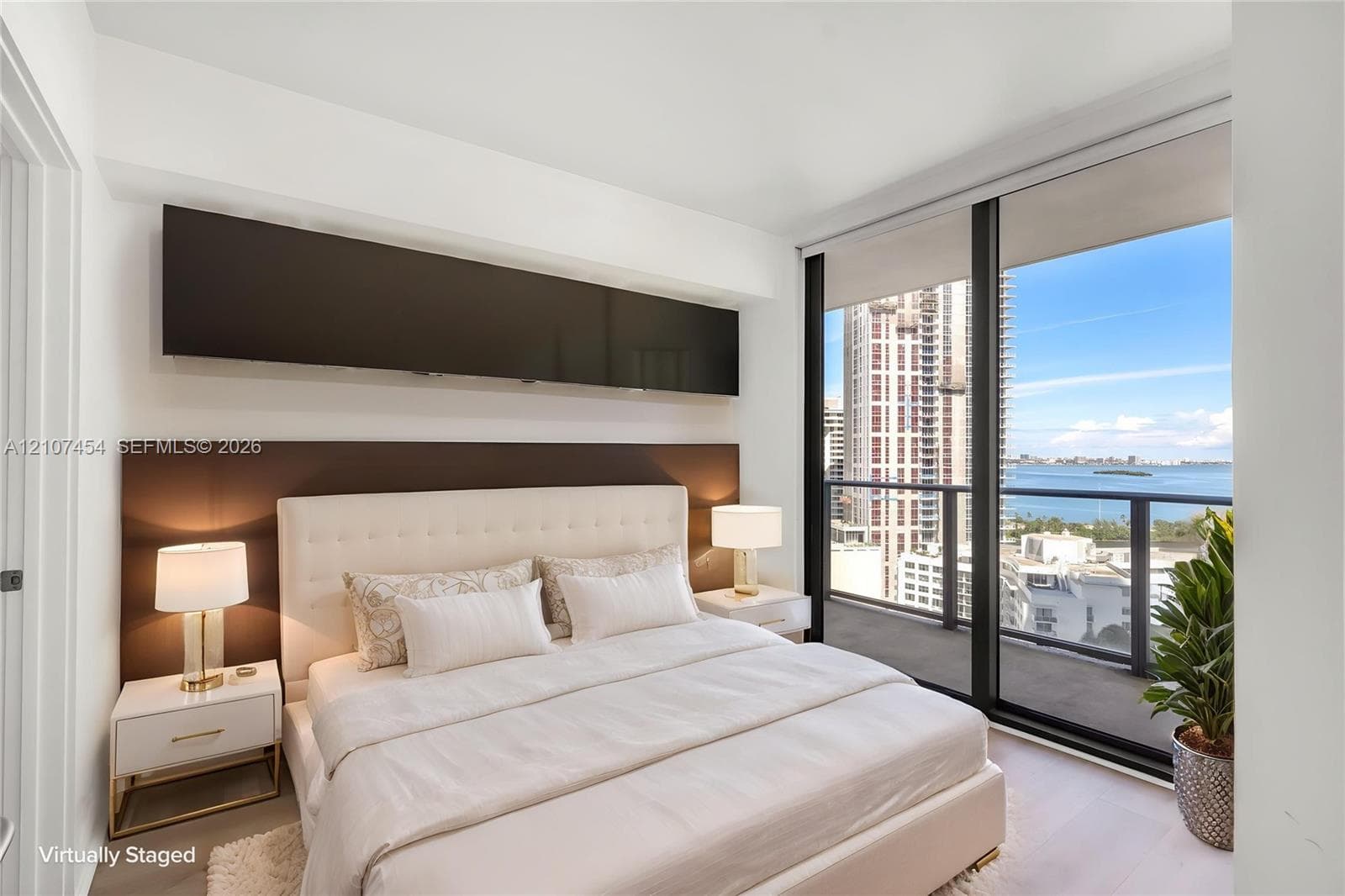 Floor-to-ceiling windows, built-in horizontal cabinetry, wood-finish flooring, and a private balcony