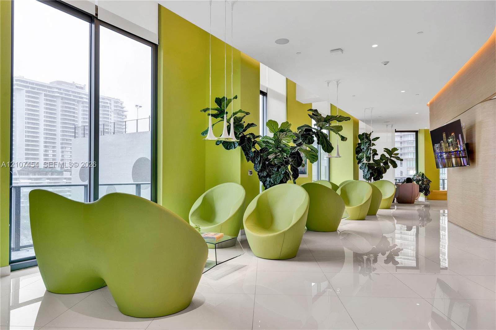 Floor-to-ceiling windows, polished tile flooring, recessed ceiling lighting, and suspended pendant fixtures