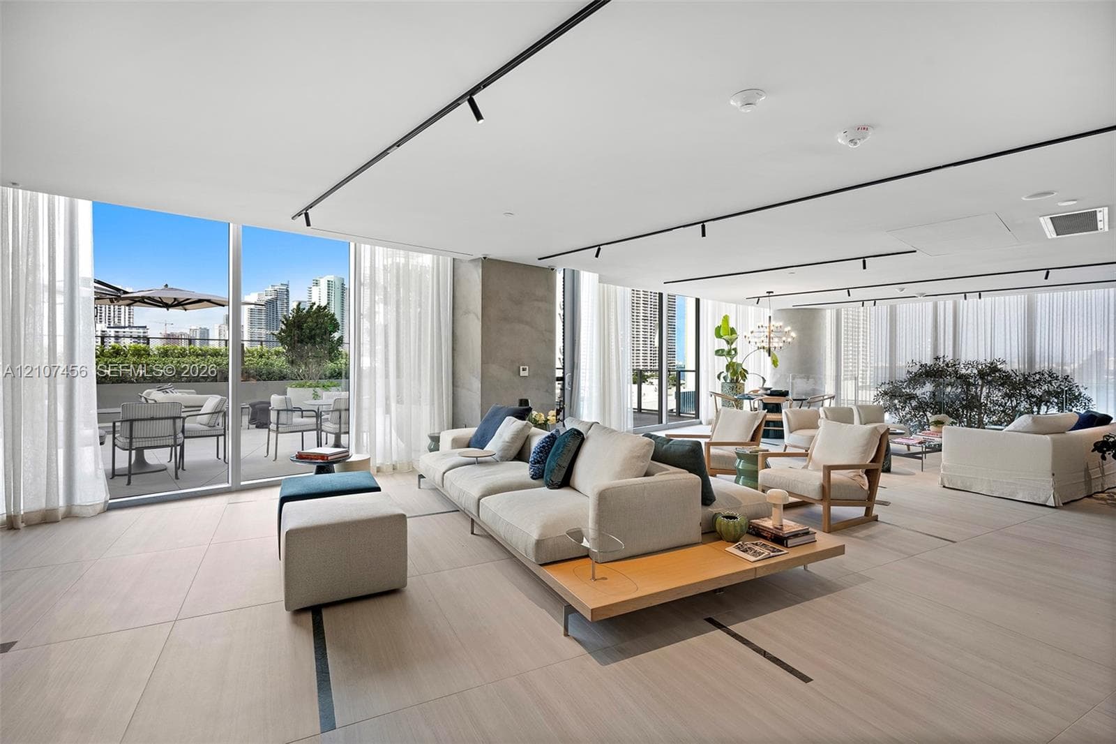 Large-format tile flooring, floor-to-ceiling glass walls, integrated track lighting, and a private terrace
