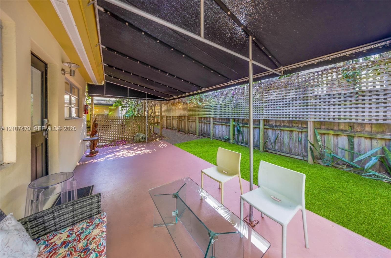 Level lot featuring mature trees, established shrubbery, and a paved street frontage