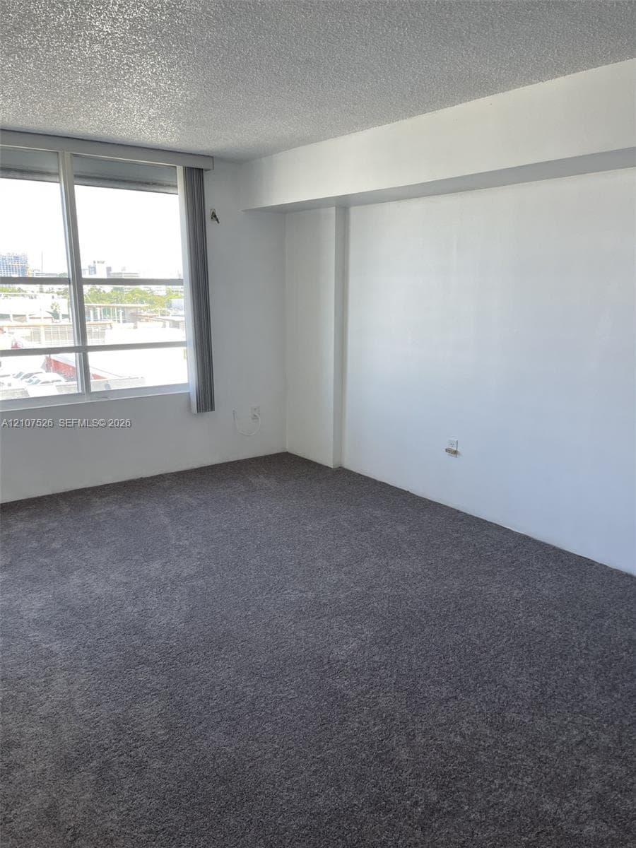 Interior space featuring wall-to-wall carpeting and large windows with exterior exposure