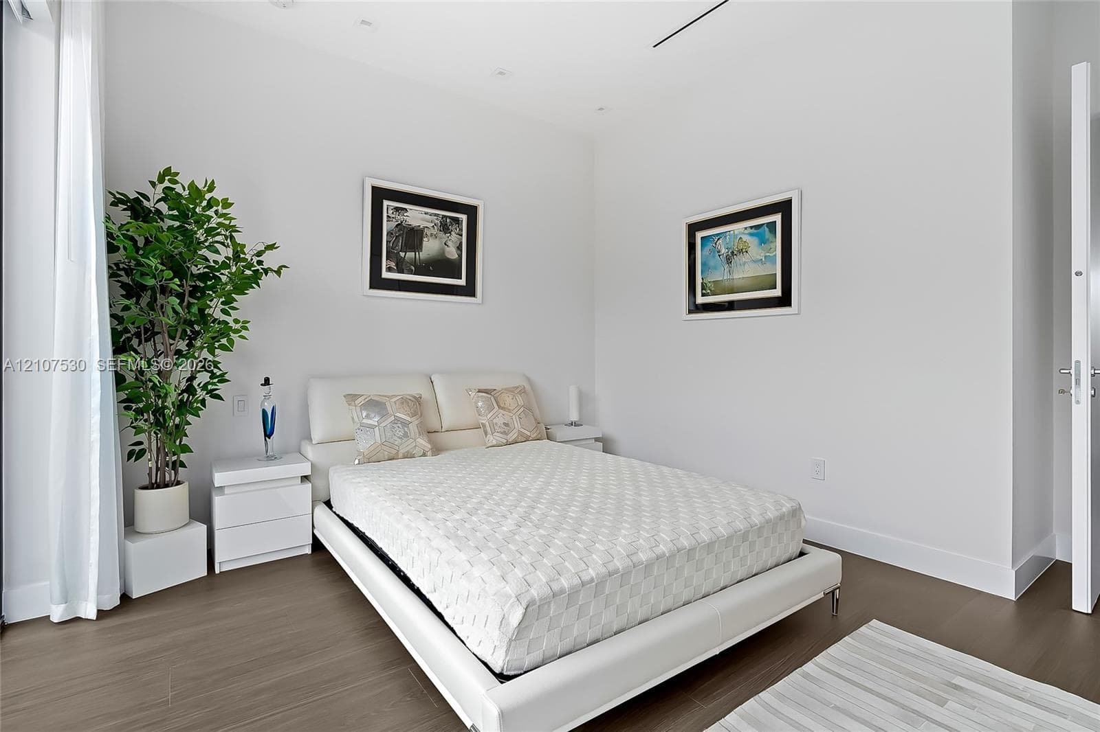 Neutral color palette, wood-finish flooring, recessed ceiling lighting, and smooth-finish walls