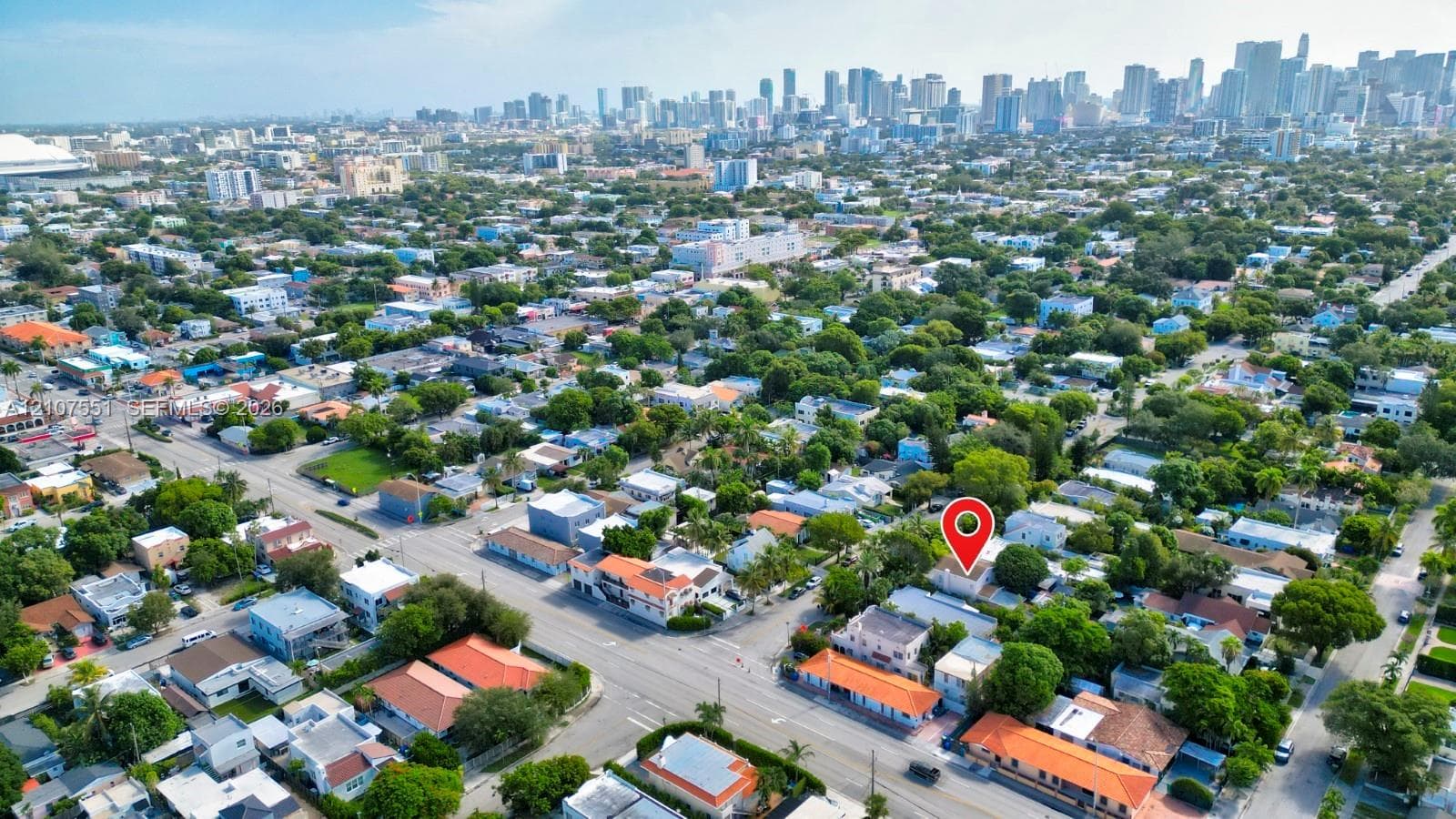 Aerial perspective featuring an urban neighborhood setting with a skyline backdrop