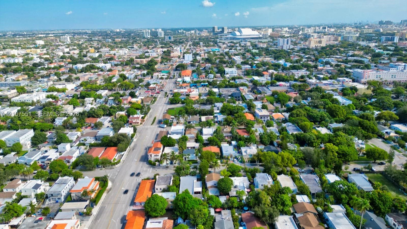 Aerial perspective featuring a dense urban street grid, established tree canopy, and proximity to major commercial infrastructure