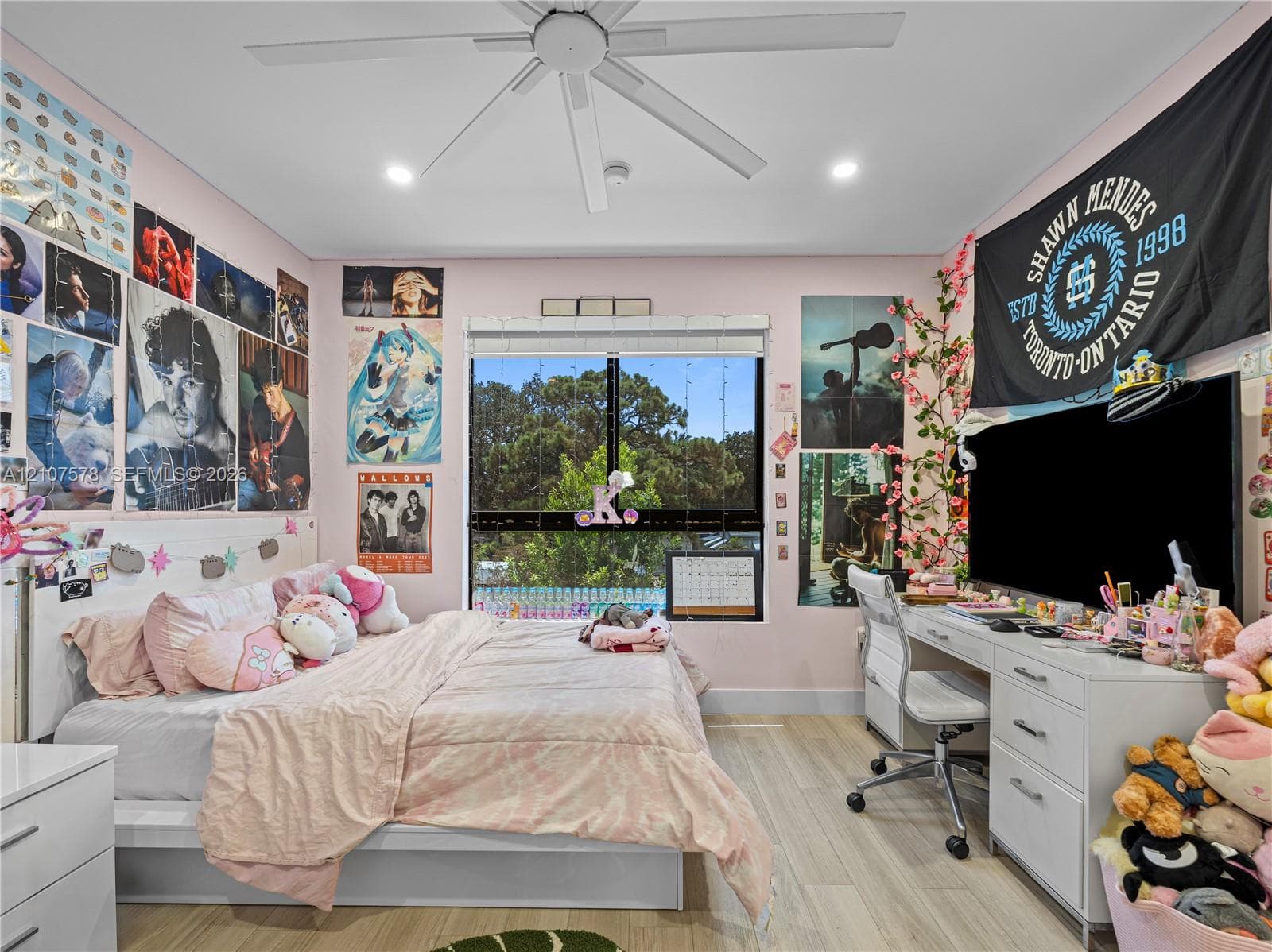 Bedroom featuring wood-finish flooring, a contemporary ceiling fan, recessed lighting, and a window with exterior scenery