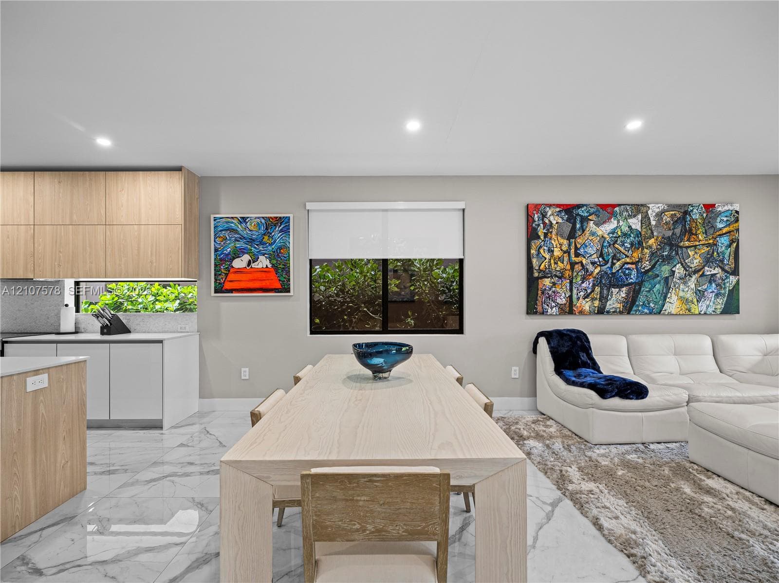 Kitchen featuring wood-finish cabinetry, white slab cabinetry, stone-finish flooring, and recessed ceiling lighting