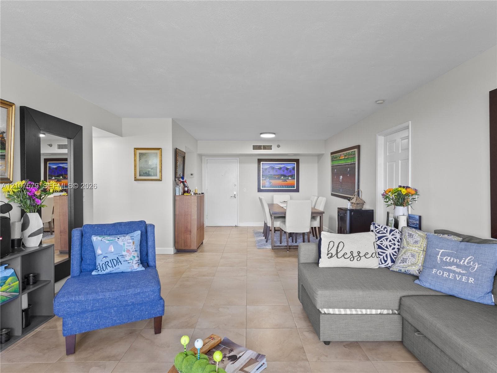 Neutral ceramic tile flooring and recessed ceiling lighting