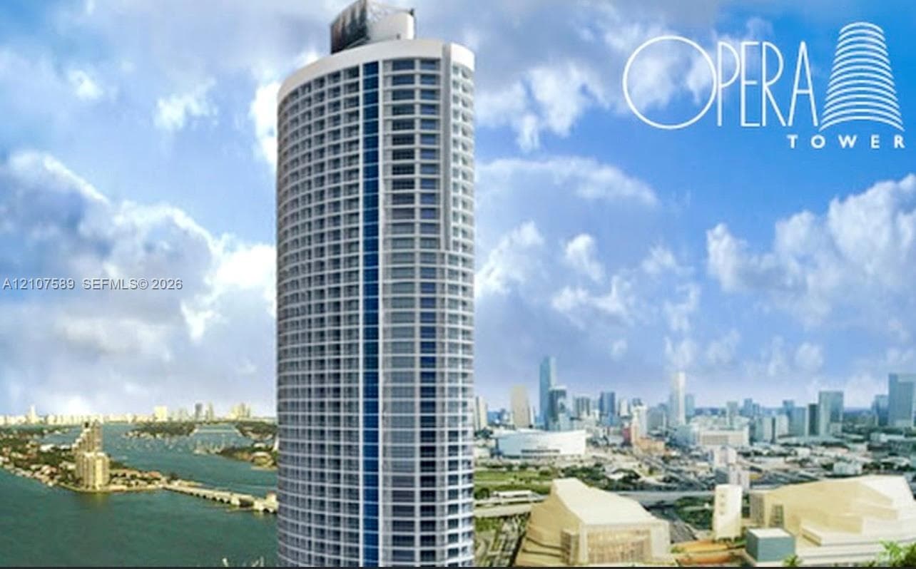 High-rise residential tower featuring a cylindrical glass facade, external balconies, and structured concrete architecture