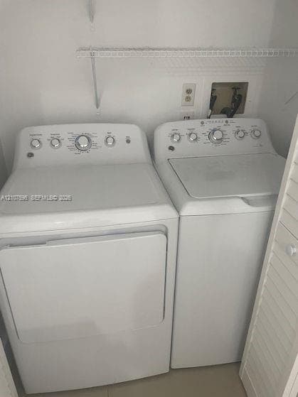 Laundry space featuring a top-load washer, a front-load dryer, and overhead wire shelving